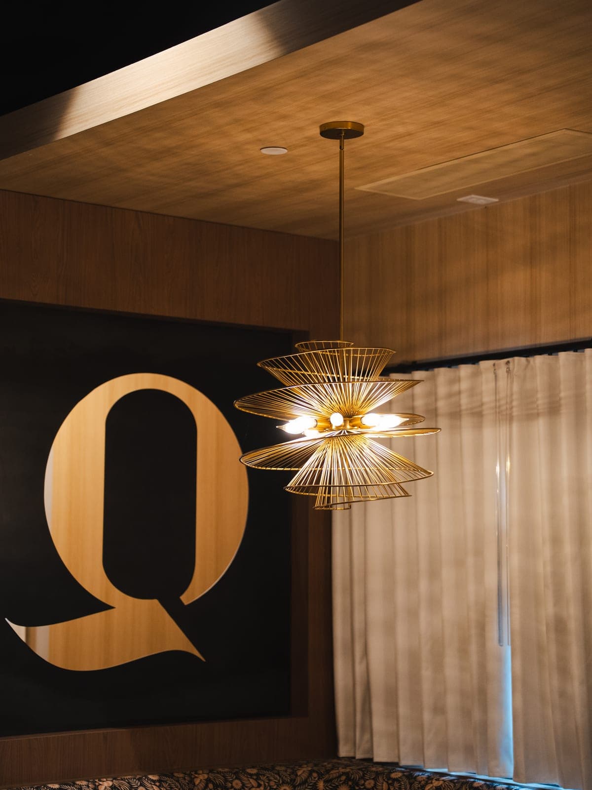 The Quiriego Q beneath a golden pendant lamp