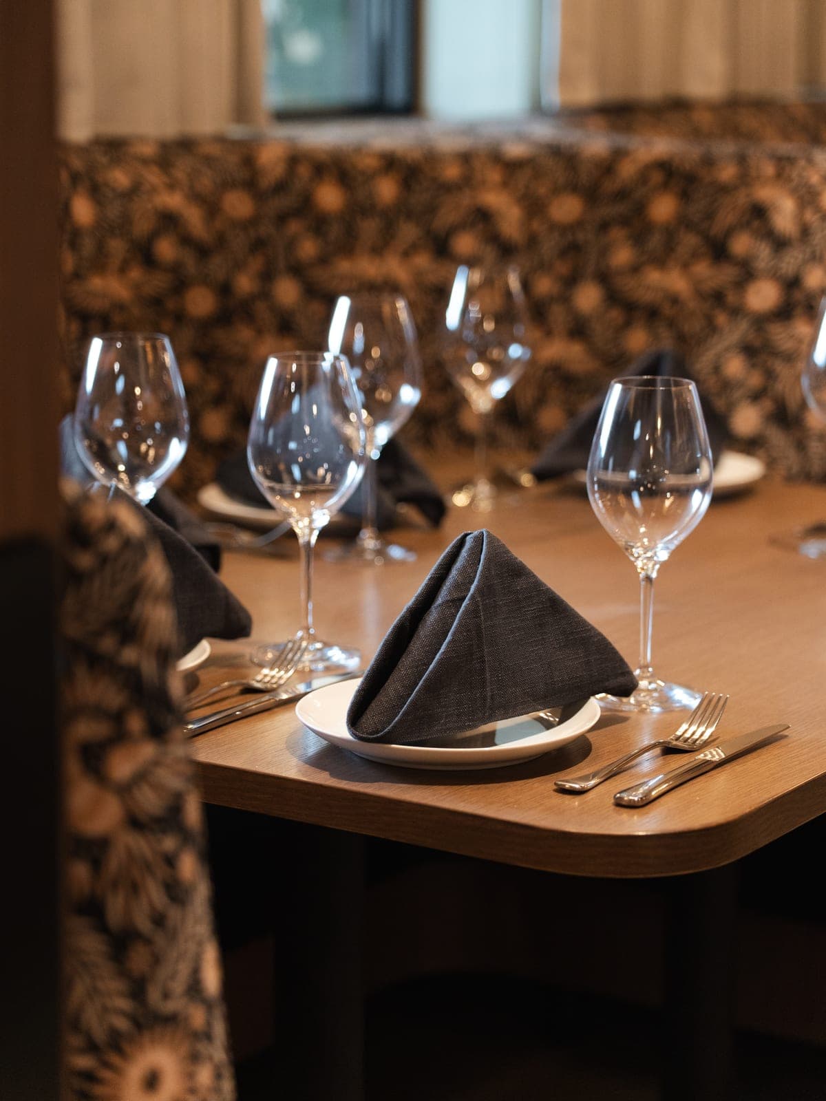 A table set beside a patterned banquette