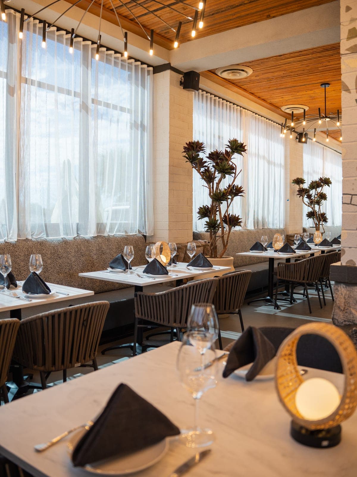 A bright dining room set for service